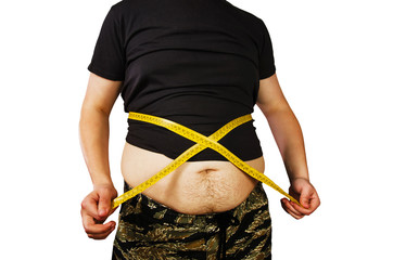 Corpus of young fat man dressed in gray t-shirt measures the belly with a measuring tape isolated...