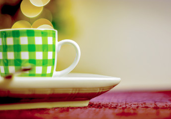 Obraz na płótnie Canvas white coffee cup with green stripes