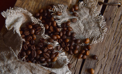 coffee beans in burlap on wooden table