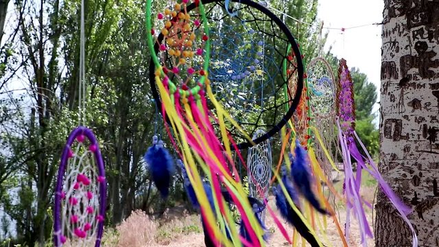 Dreamcatcher sunset , the mountains, boho chic, ethnic amulet,symbol. Dream catchers are swaying in the wind on a clear summer day.