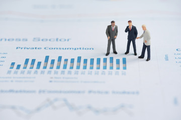 business miniature people on business graph