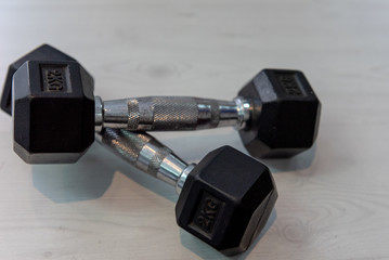 Set of metal dumbbells on rack in the gym. Sport club equipment for weight training.