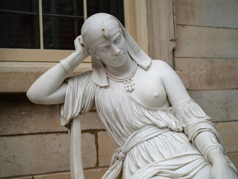 19th century carving of Cleopatra, the last Macedonian ruler of Egypt. Statue depicts her meditating suicide.