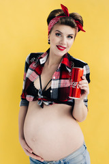 pregnant girl in the style of pin-up with a bottle of soda