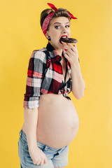 pregnant girl in pin-up style eating a chocolate donut