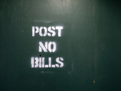 Post no bills spray painted warning sign at a city construction area