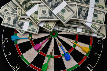 Finance Business Concepts. Businessman is playing darts. Businessmen are aiming for work. Businessman looking at a lot of money.