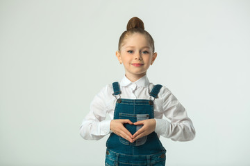 beautiful little smiling girl on a light background