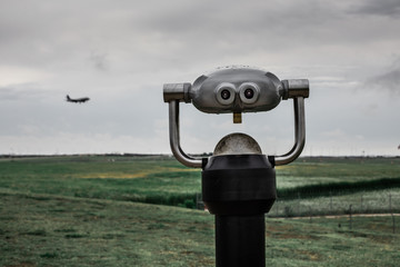 Tower viewer with silhouette of plane landing in the background