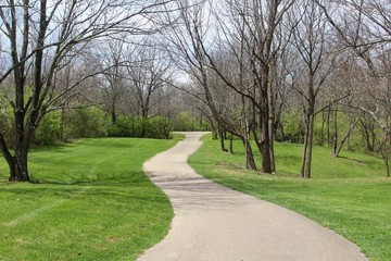 The winding pathway in the park on a sunny spring day.