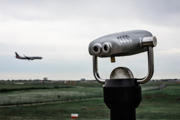 Tower viewer with silhouette of plane landing in the background