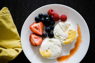 poached eggs and fruit breakfast