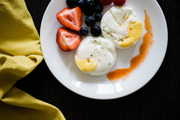 poached eggs and fruit breakfast