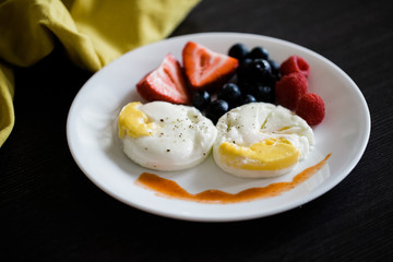 poached eggs and fruit breakfast