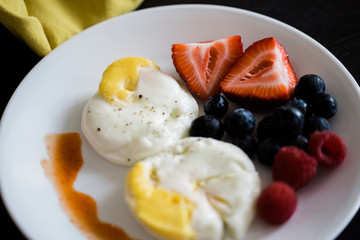 poached eggs and fruit breakfast