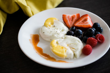 poached eggs and fruit breakfast