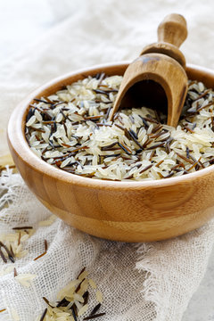 Mixture of white and wild rice in a wooden bowl.