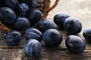 Ripe and sweet plums on wooden table