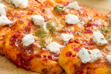 tris of mixed pizza on wood with ingredients