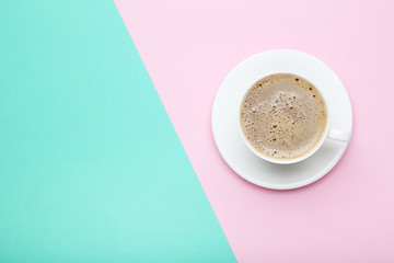Cup of coffee on colorful background