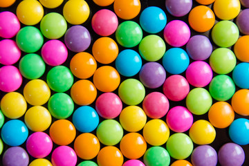 Pile of colorful sweet candy chocolates coated background. colourful collection