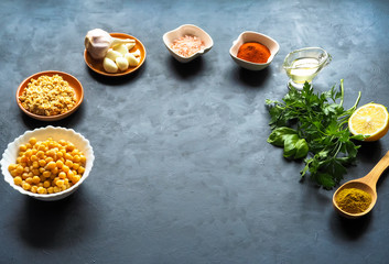 Ingredients for hummus on the black kitchen table. Top view.