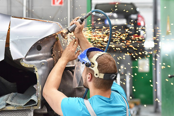 Karosseriebau - Mechaniker repariert Unfallschaden am Auto in einer Werkstatt // Body construction...