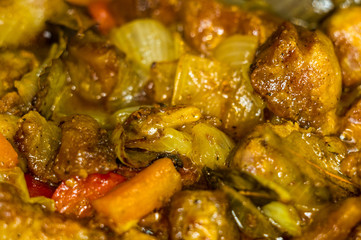 Roast meat, onions, carrots and spices, boiling in oil