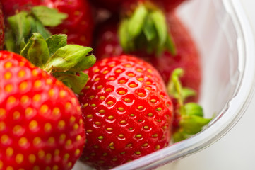 fresh ripe strawberries on black ceramic plate