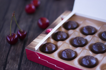 Chocolate sweets with cherry liqueur in paper box.