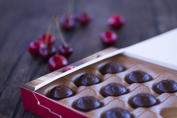 Chocolate sweets with cherry liqueur in paper box.