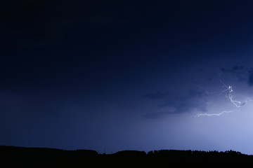Thunderstorm in blue dark sky