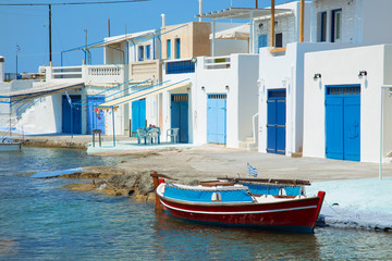 Fototapeta na wymiar Fishing boat with a village in background