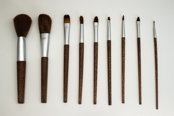 Makeup brushes for applying foundation and blush, in a row