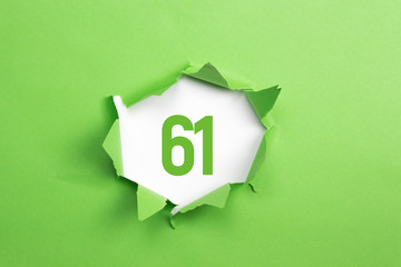 gruene Nummer 61 auf gruenem Papier