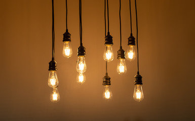 Hanging light bulbs against a neutral wall