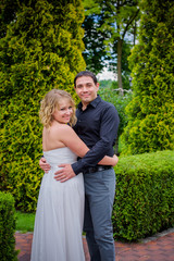 Bridal wedding plus size couple woman and man sitting with heads together on park.    