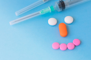 Medication, colourful pills, flat lay on blue background