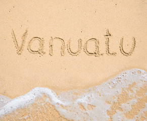 The word Vanuatu written in the sand on beach