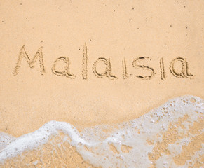 The word Malaisia written in the sand on beach