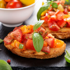 Italian bruschetta with chopped tomatoes and basil   on grilled crusty bread.