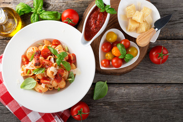 Pasta with spicy tomato sauce, parmesan and basil. top view.