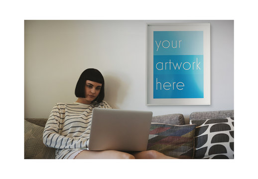 White Framed Poster with Laptop User at Home Mockup
