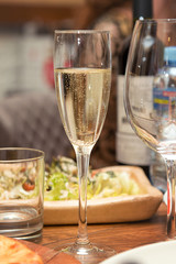 A glass of champagne on the holiday table close-up.