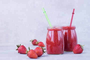 Strawberry smoothies on gray background.