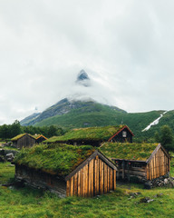 Obraz premium Typical norwegian old wooden houses with grass roofs in Innerdalen - Norway's most beautiful mountain valley, near Innerdalsvatna lake. Norway, Europe