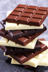 chocolate in different color. milk, dark and white chocolate bars