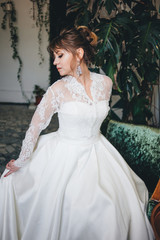 pretty woman in a wedding dress in the depressions of living plants.