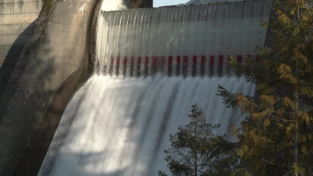 Dam Spillway 4K. UHD. Water pours over the spillway of dam. 4K. UHD.

