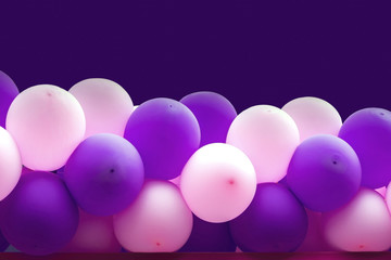 Bundle of balloons pink and purple background